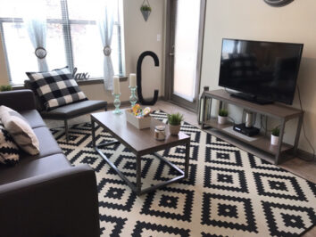 Living room area with TV and dark couch